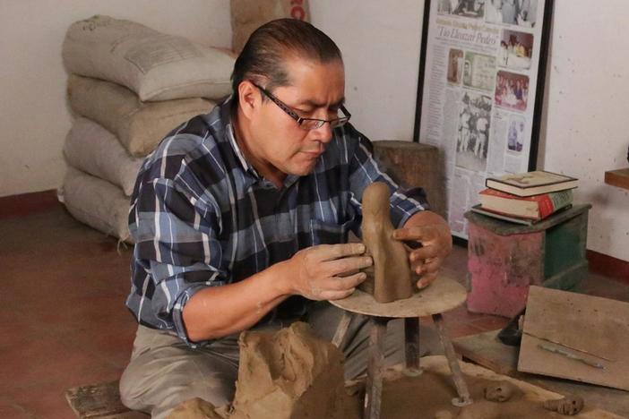 Ceramic artist Carlomagno Pedro Martínez sculpts and assembles a skeleton figure