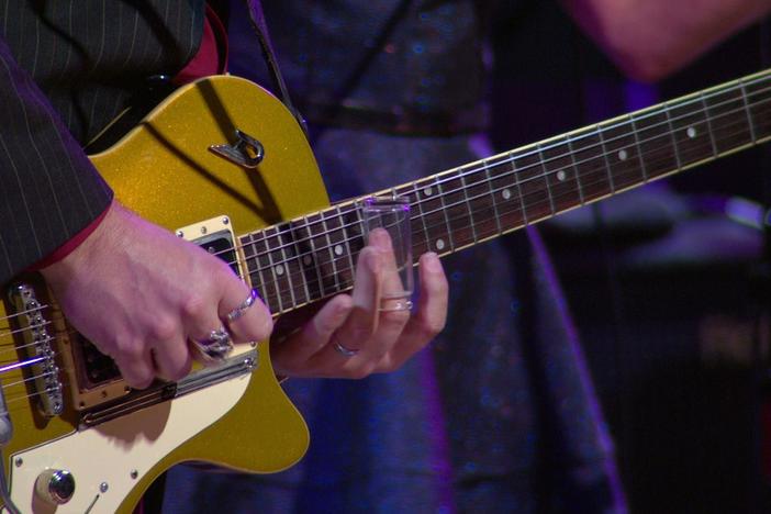 The acclaimed rocker gives due respect to his new acoustical guitar.