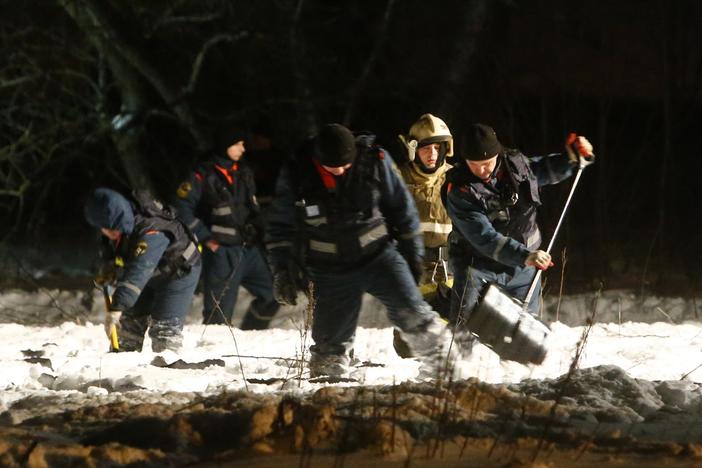 Investigators combed through wreckage of a jetliner crash that killed everyone on board.