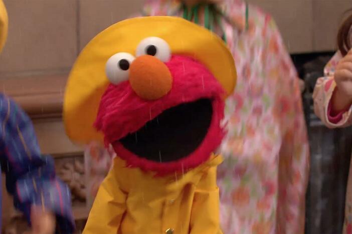 Elmo sings about jumping in puddles.