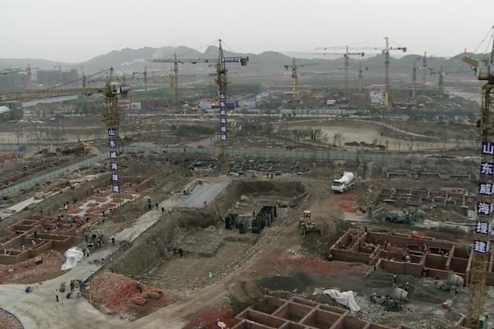 A news report announces the construction of the new Beichuan city.