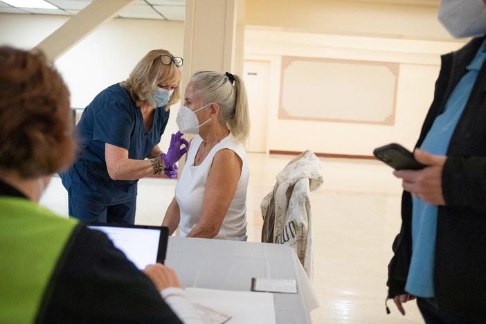 Updated COVID boosters approved ahead of potential fall surge