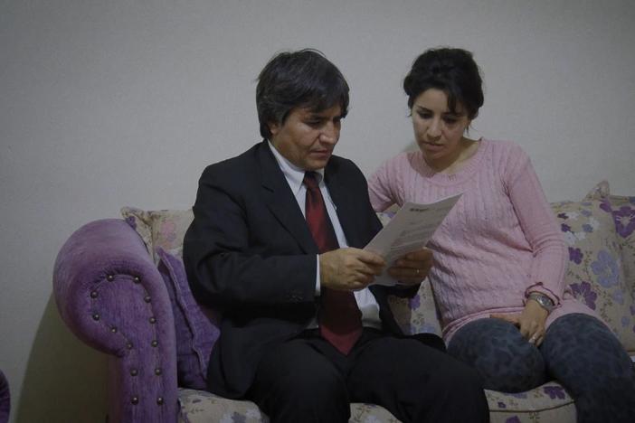 Sahand reads aloud the decision in his case.
