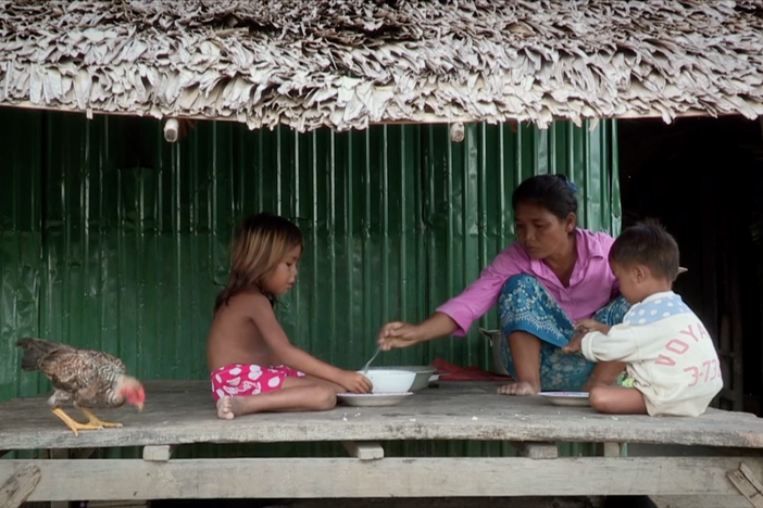 Aya's mother berates her daughter for returning from Malaysia with a child.