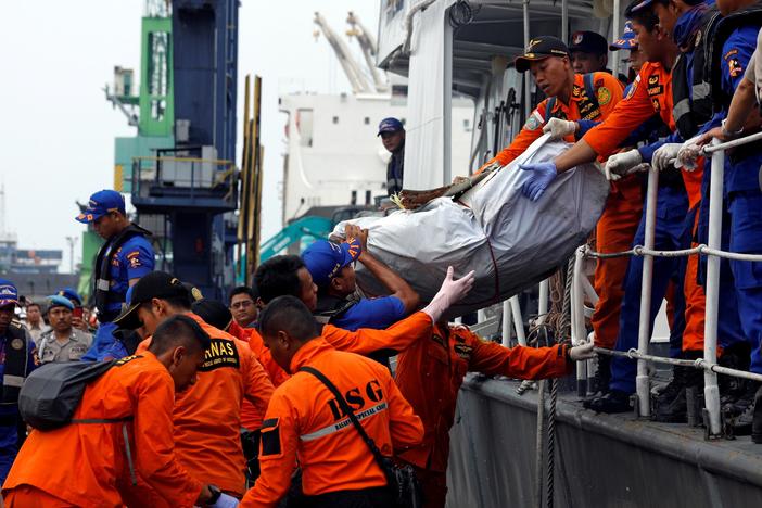 News Wrap: Rescue crews recover bodies, wreckage from Indonesian plane crash