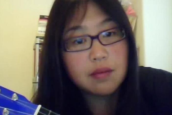Student Freedom Rider Esther Kim sings and plays "We Shall Overcome" on the ukulele.