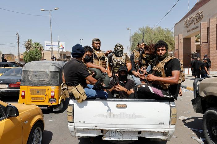 News Wrap: Violence in Iraq kills dozens, U.S. says Iran tried to steal its drone