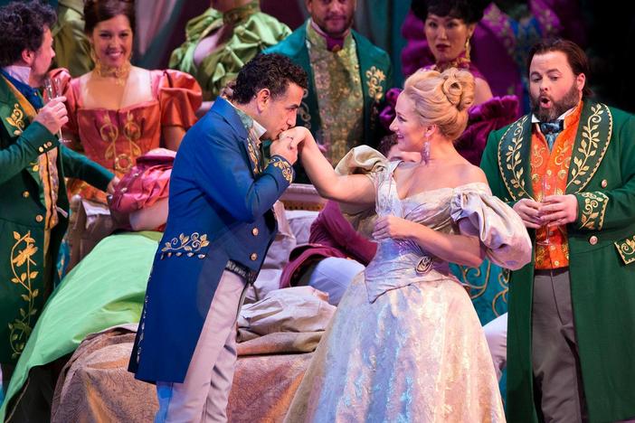 Watch a lively excerpt of "Libiamo ne' lieti calici."
