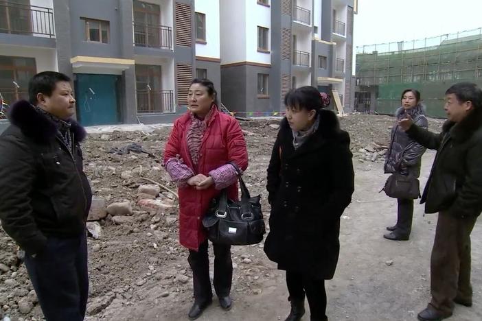 Li Guihua and her neighbors compare the environment of new Beichuan to their old city.