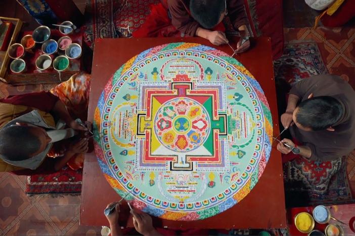 Buddhist monks create a Sand Mandala masterpiece, while in a state of meditation.