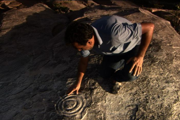 Examining the petroglyphs on the Rock of the Ingá