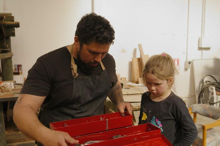 With help from her father, a girl fixes her bike and learns about the importance of tools.