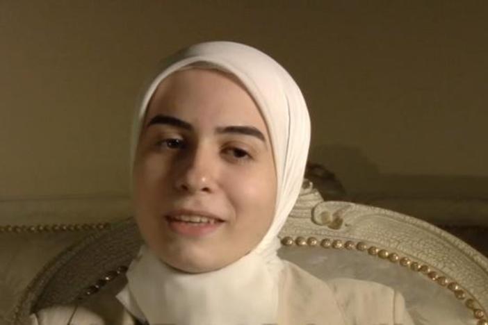 A Qur'an student recites a sura, then explans why this sura has special meaning for her