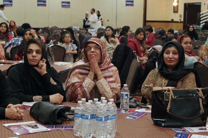 Bushra Amiwala speaks to a group of Pakistani community members.