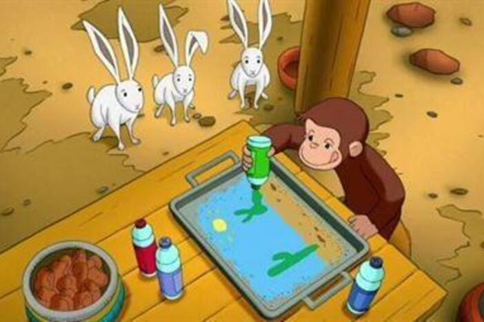 George creates a colorful "painting" with sand.