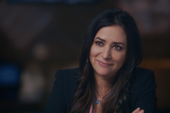 Pamela Adlon looks at a photo of her great-great grandfather’s gravestone.