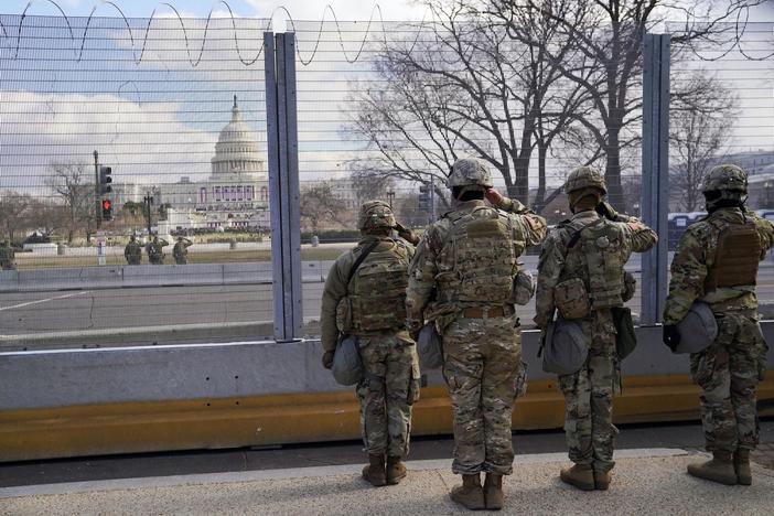 Peaceful transfer of power ensues amid massive show of force