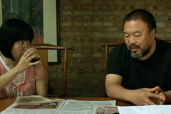 Ai Weiwei discusses his tax evasion charge with his lawyer.