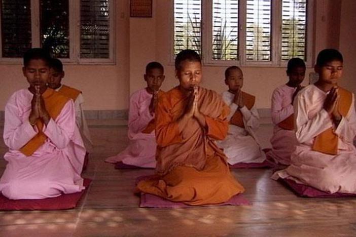 A devoted gathering of monks formed around the Buddha at Sarnath.