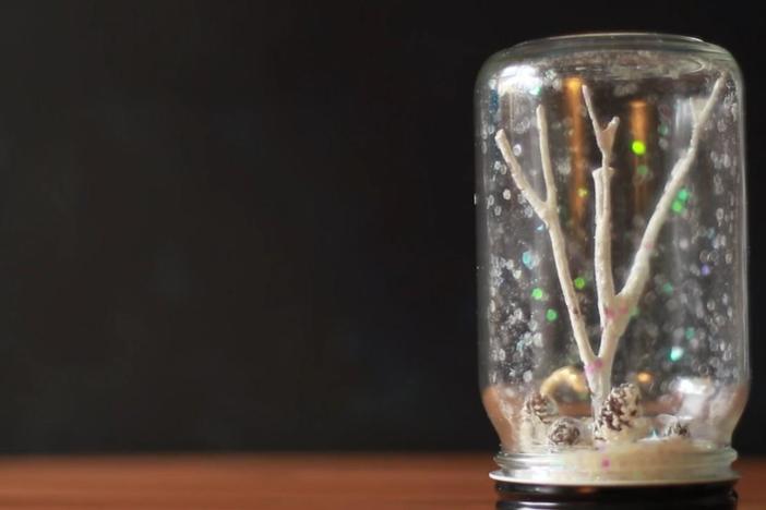 Turn a jar, twigs, pinecones, and trinket toys into a Winter Wonderland Terrarium.