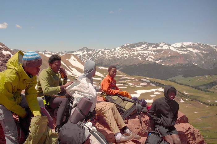 Watch these teens attempt to traverse a snow-packed mountain side.