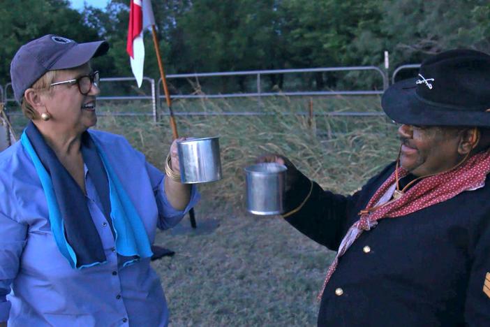 Lidia and Wallace cook food over an open fire, in the tradition of the Buffalo Soldiers.