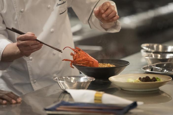 Chef Alan Ji prepares lobster ma pa tofu for Marcus at Las Vegas restaurant Mott 32.