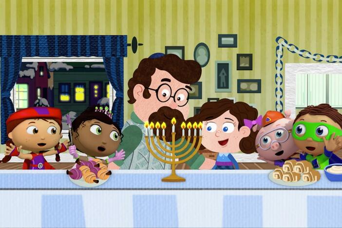 The Super Readers sing 'Oh Chanukah' while they light the menorah.