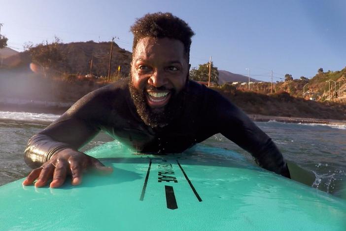 Baratunde surfs with Color the Water, a BIPOC surfing group in Los Angeles.