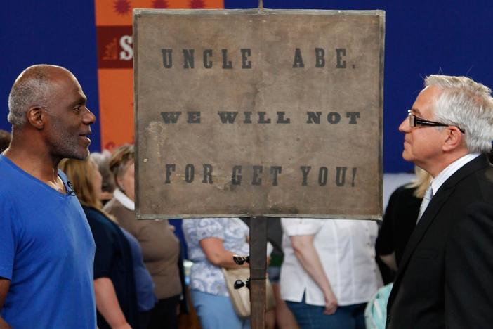 Wes Cowan appraises a Lincoln mourning parade banner from 1865.