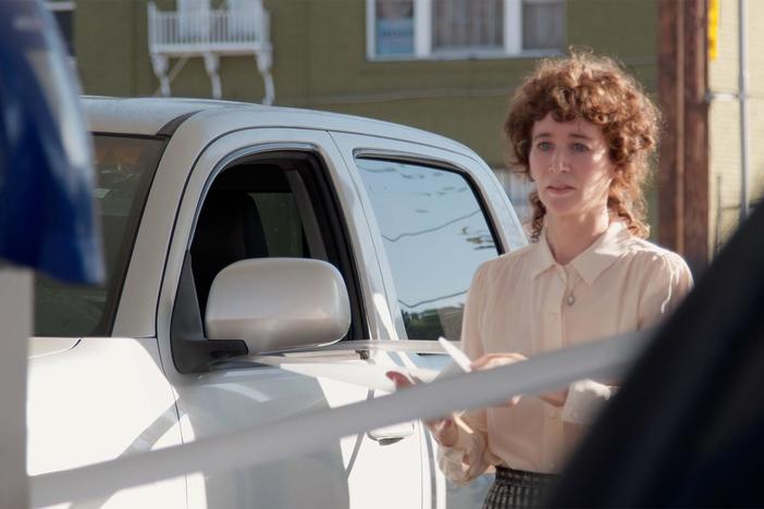 Artist Miranda July performs at a gas station in Los Angeles, California.