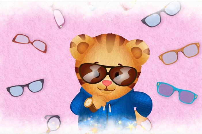 Daniel makes believe that he tries on all different kinds of eye glasses.