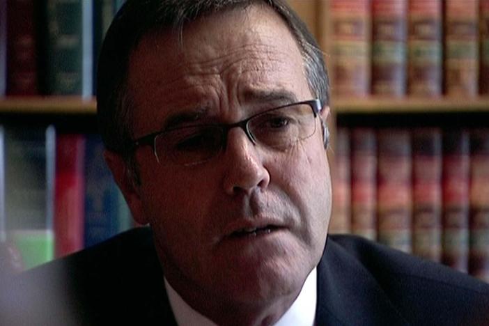 A lawyer reviews the list of land recipients under Mugabe's land redistribution.