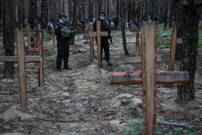 Ukraine examines bodies from mass graves discovered after regaining territory from Russia