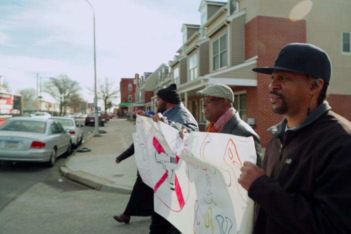 The community responds to a shooting with a protest march.