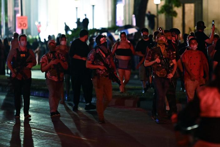 What legal standing do armed civilian groups at protests have?