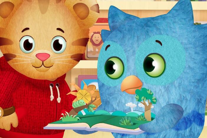 X is reading a story to Daniel and O, but O keeps bringing over more books to read later.