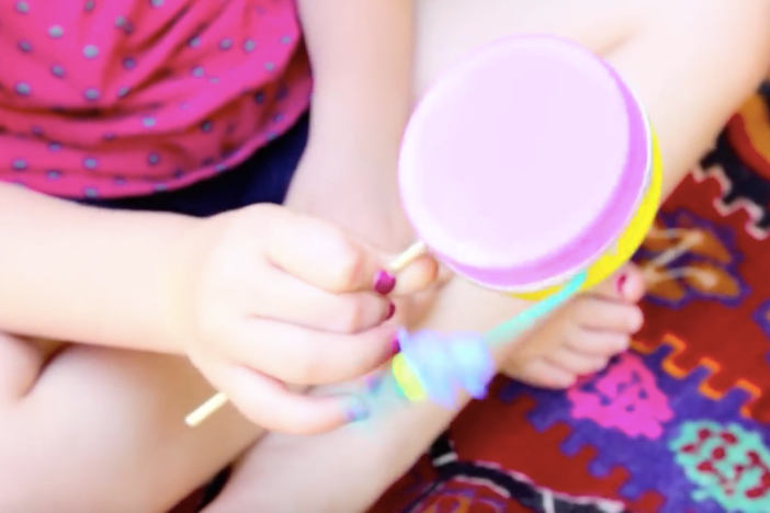 Easily make a simple toy and instrument  – the classic rattle drum – with your kid.