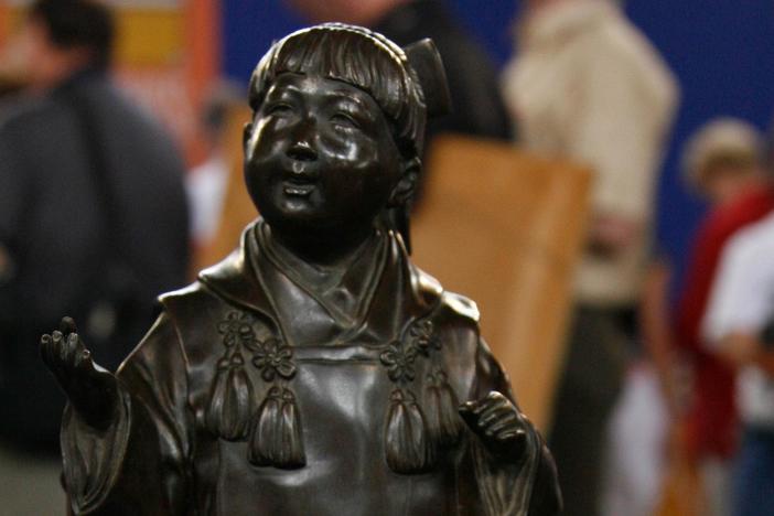 James Callahan appraisees a Tokyo Japanese bronze, ca. 1900.