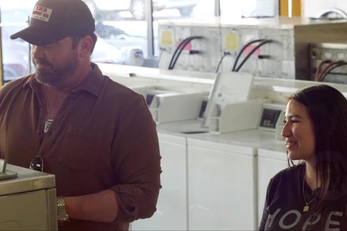 Ashley Ruiz shows singer/songwriter, Lee Brice, around a Laundry Project event.