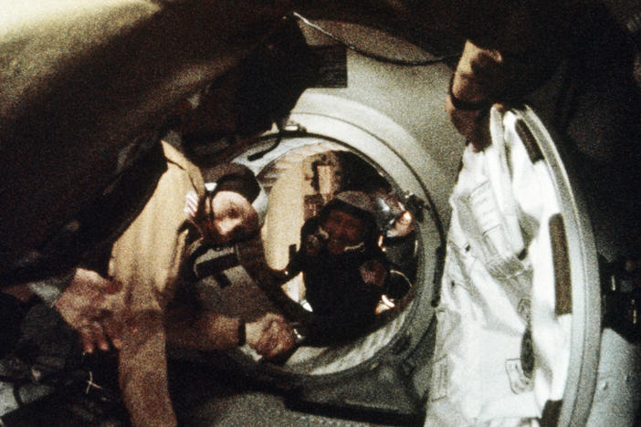 Astronaut Tom Stafford (left) and cosmonaut Alexey Leonov shake hands after the first docking of U.S. and Soviet spacecraft in 1975.