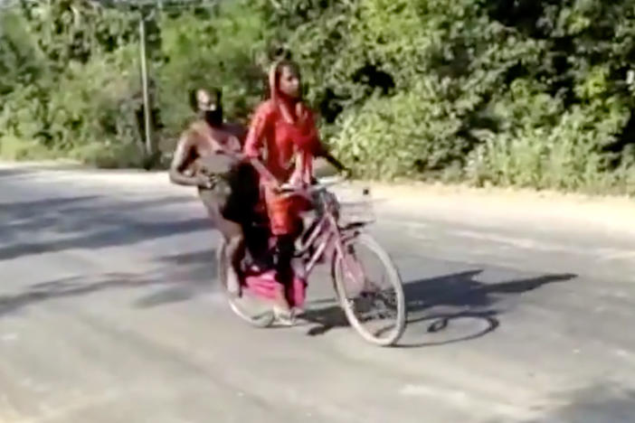 In this screengrab from video posted by BBC News Hindi,15-year-old Jyoti Kumari's rides with her father during their 700 mile-long journey to their family's village of Sirhulli in eastern India.