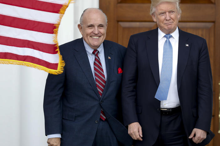 Rudy Giuliani is seen here with Donald Trump shortly after Trump's election victory in 2016. Federal authorities raided Giuliani's apartment Wednesday, the former New York City mayor's attorney said.