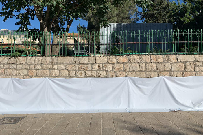A pro-LGBTQ banner is flipped over on a wall outside the U.S. Embassy in downtown Jerusalem.