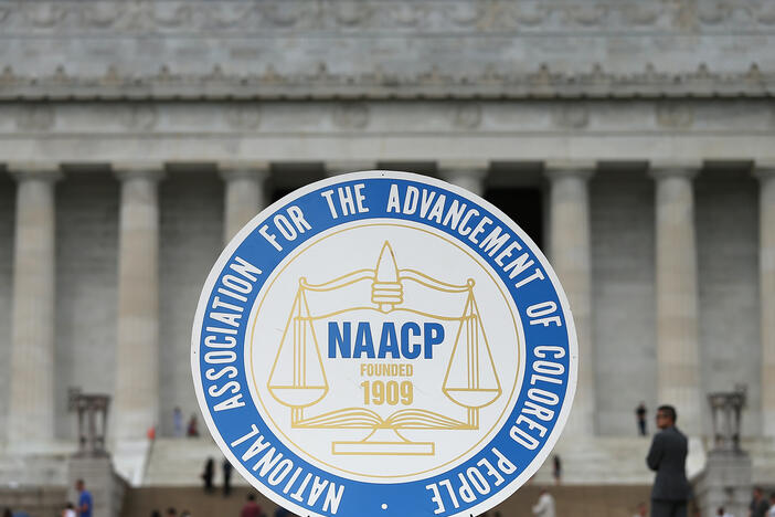 The NAACP logo is shown during an event at the Lincoln Memorial in Washington, D.C., in 2015. The civil rights group has announced it won't invite President Trump to address its convention, breaking a 116-year tradition of inviting sitting presidents.