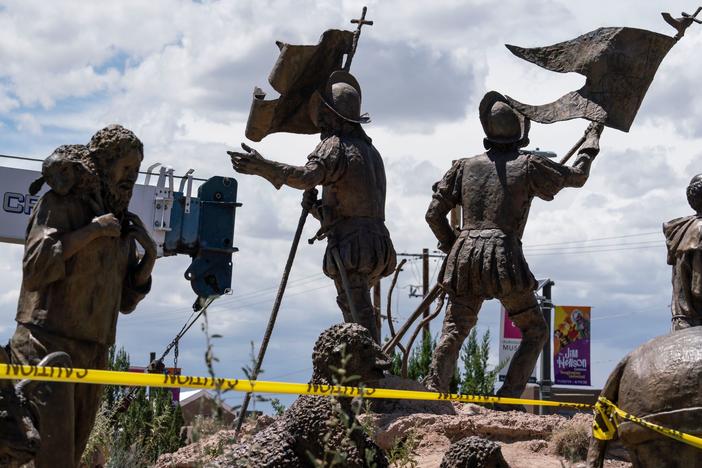 A sculpture of Juan de Oñate's settlers arriving in New Mexico is pictured as city workers remove a sculpture of the Spanish conquistador on June 16 in Albuquerque.