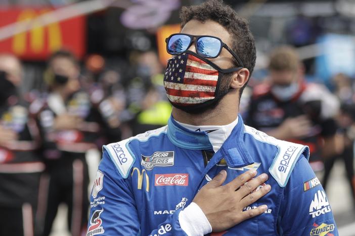 NASCAR Cup Series driver Bubba Wallace stands during the national anthem before a NASCAR auto race Sunday at the Indianapolis Motor Speedway in Indianapolis.