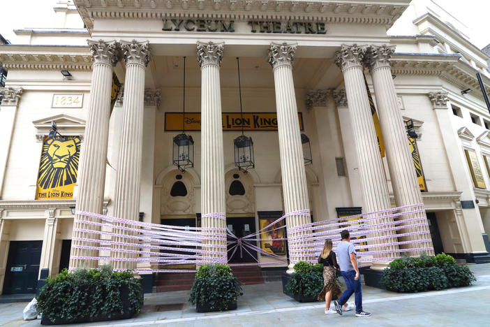 London's Lyceum Theatre is wrapped in pink tape bearing the words "Missing Live Theatre," part of a campaign by a group of British stage designers.