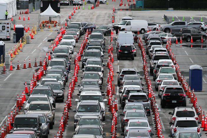 Lines and lines of cars are seen as drivers wait on Monday to be tested for COVID-19 at a coronavirus testing site in Miami Gardens, Fla.