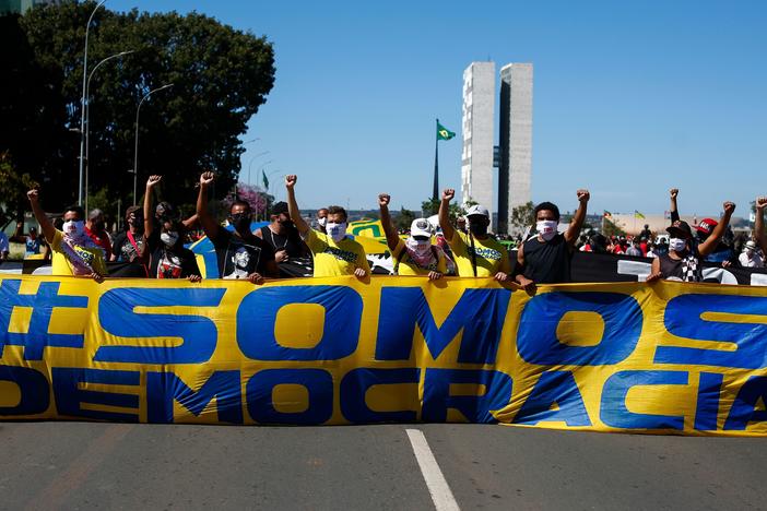 Demonstrators carry a banner that says, "We are democracy" during a protest against racism last month in Brasilia, Brazil.